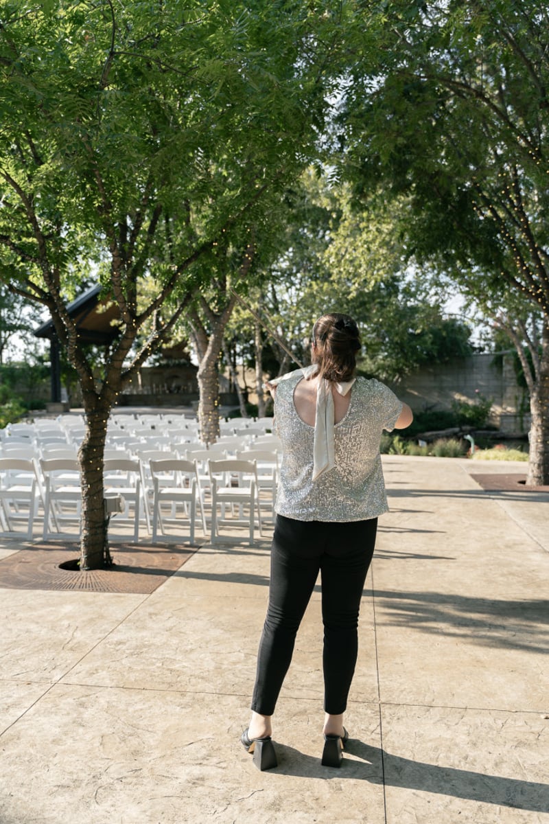 Ana Done playing violin before an outdoor wedding ceremony